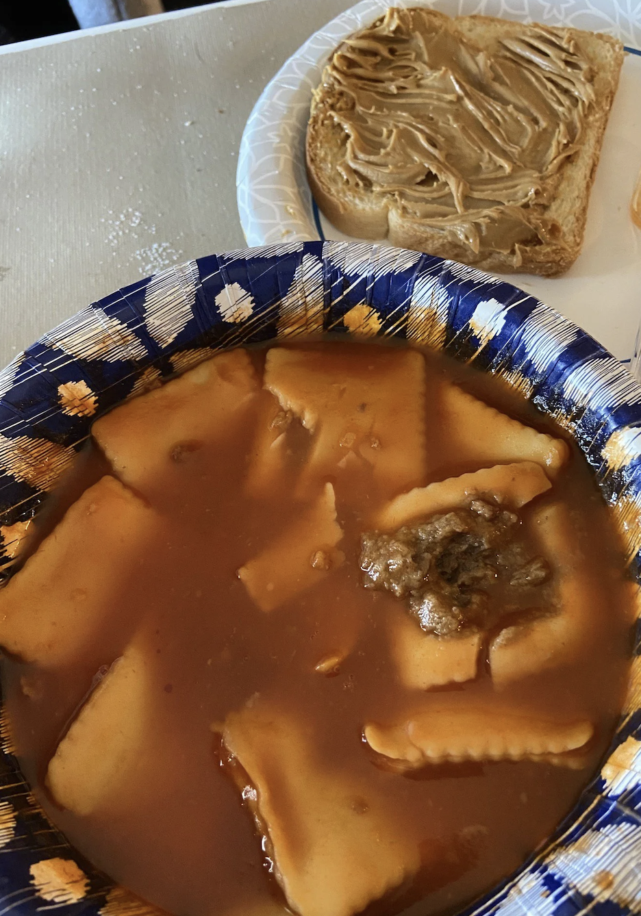 a plate of chef boyardee raviolies next to peanut butter toast