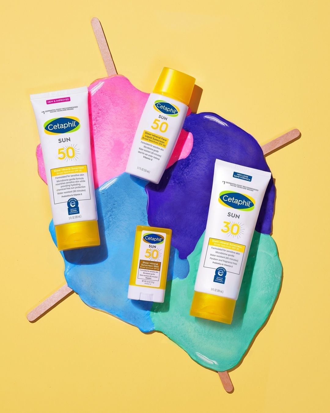 Assorted Cetaphil sunscreen products arranged on a colorful splash backdrop