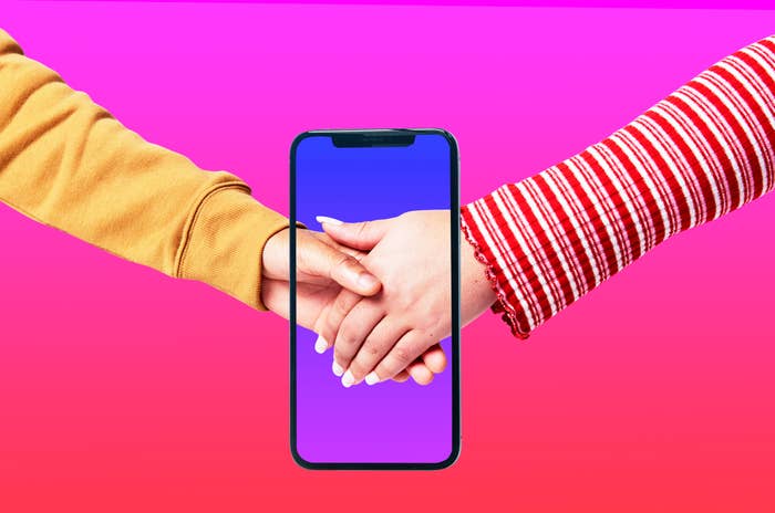 Two individuals holding hands, with a smartphone between them showing the same image, symbolizing a digital connection