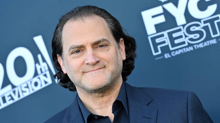 Man in a suit smiling at a FYC Fest event