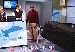 A SNL skit featuring a person with a giant bag at an airport check-in desk saying: &quot;It&#x27;ll fit. Oh, it&#x27;ll fit!&quot;