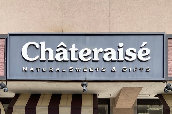 シャトレーゼの店舗正面、自然なスイーツ・ギフトの看板、窓に和菓子の広告。