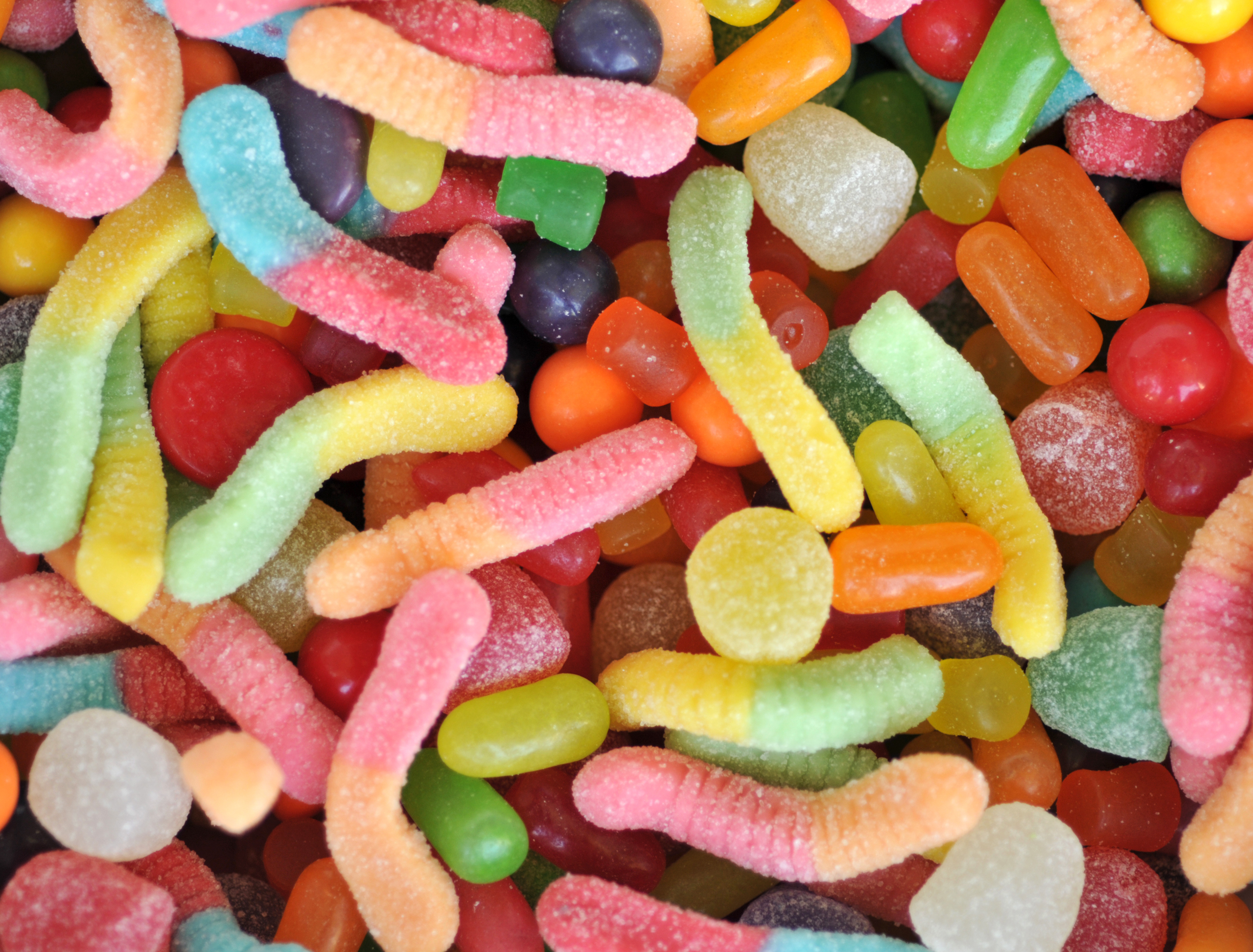 Assorted gummy candies and jelly beans in a pile