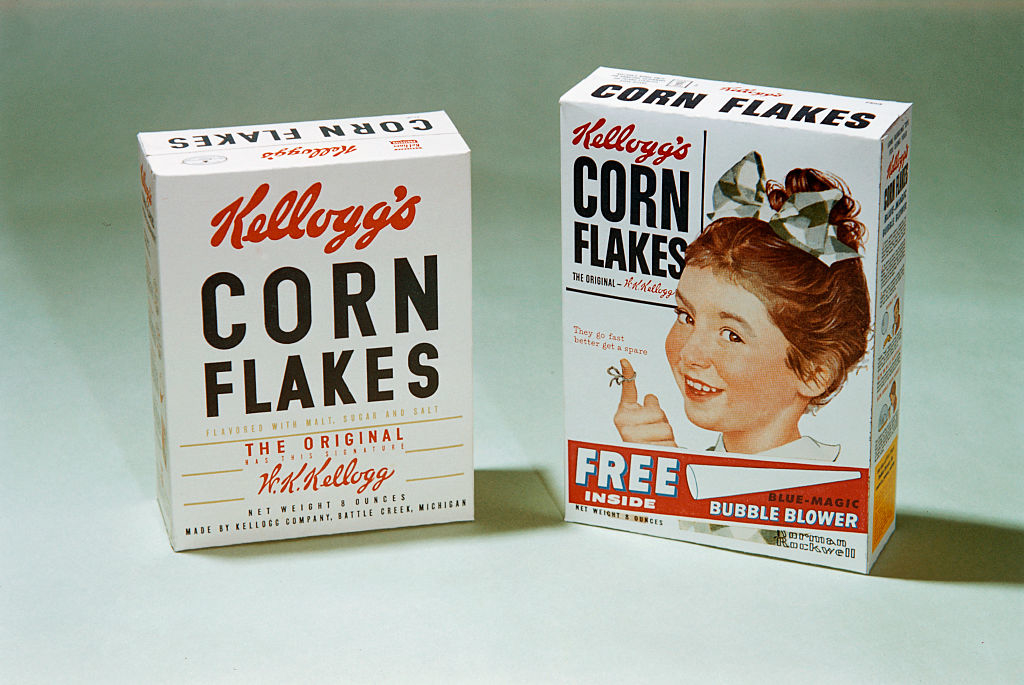 Two vintage Kellogg&#x27;s Corn Flakes cereal boxes, one advertising a free bubble blower inside