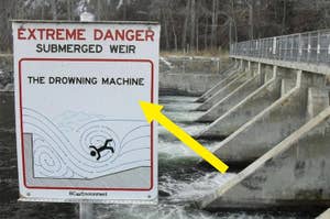 Caution sign reads "EXTREME DANGER SUBMERGED WEIR" with graphic of person in whirlpool, next to actual weir