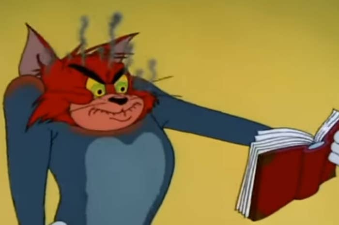 Angry cartoon cat character tears a book apart