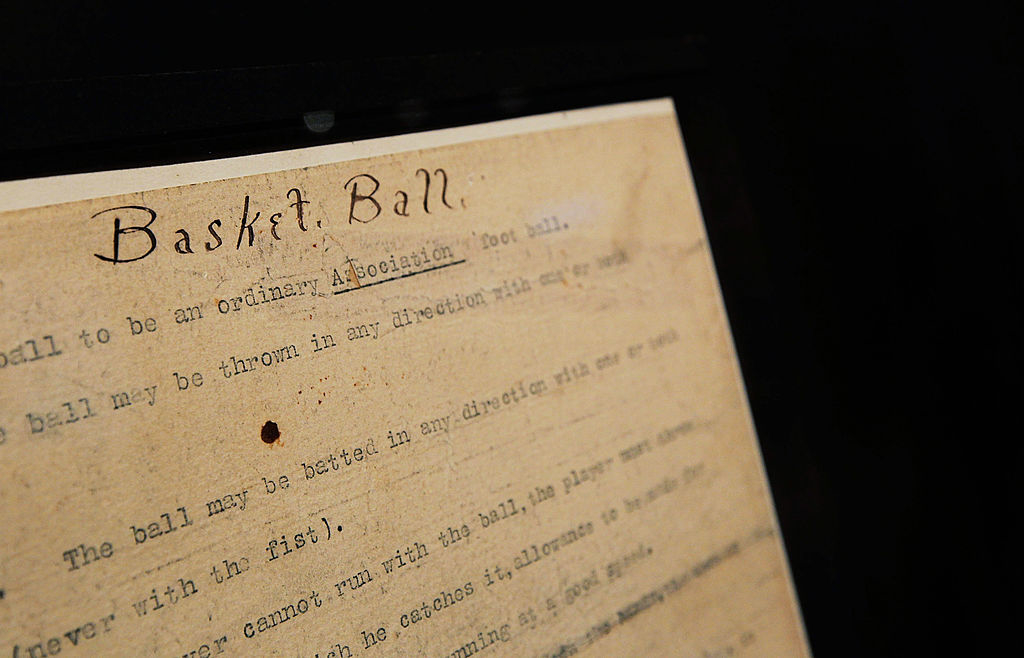 Old document labeled &quot;Basket Ball&quot; with faded text and a visible hole, detailing early rules of the game
