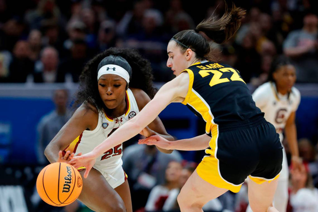 South Carolina&#x27;s Raven Johnson (25) swipes the ball from Iowa&#x27;s Caitlin Clark (22) during the National Championship game