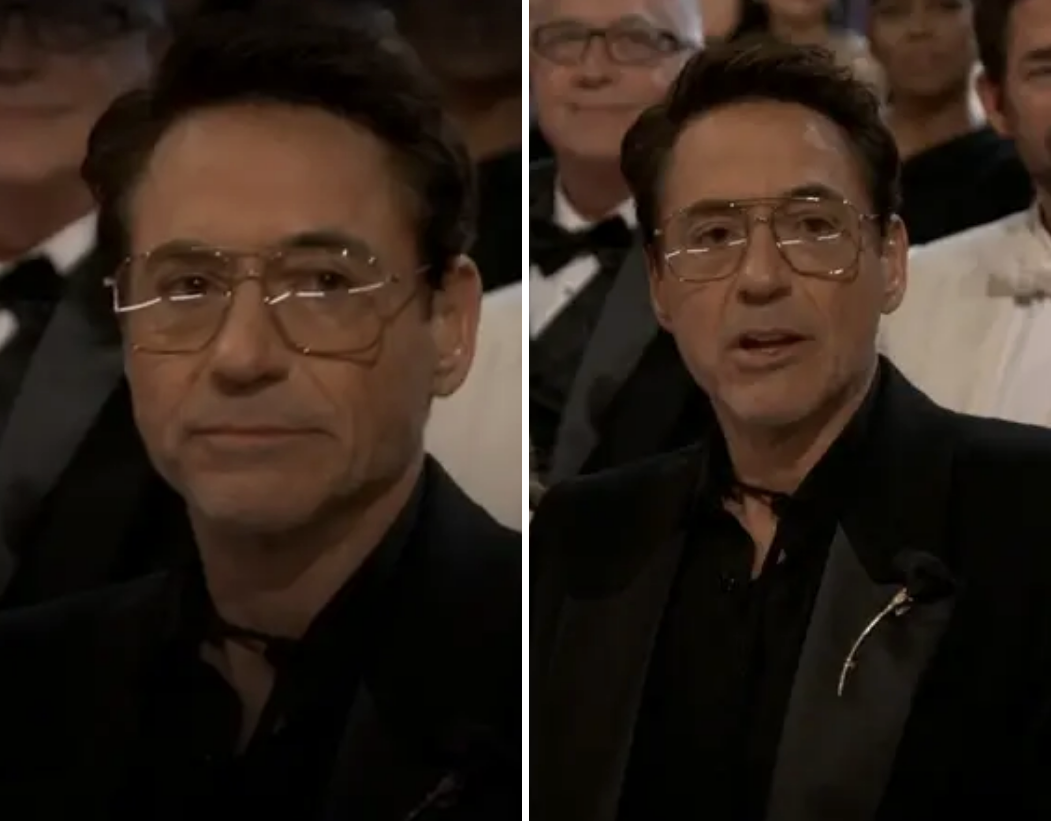 Robert Downey Jr. in formal attire at an event with a microphone on stand visible