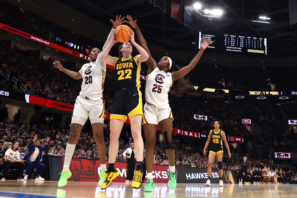 Caitlin Clark of the Iowa Hawkeyes works to shoot around Sania Feagin and Raven Johnson of the South Carolina Gamecocks in the 2024 NCAA Women&#x27;s Basketball Tournament National Championship