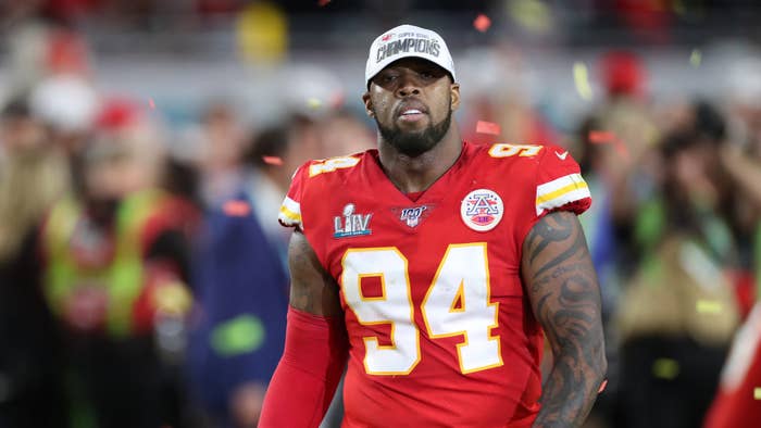 Kansas City Chiefs player in jersey number 94 on the field with &quot;Champions&quot; patch