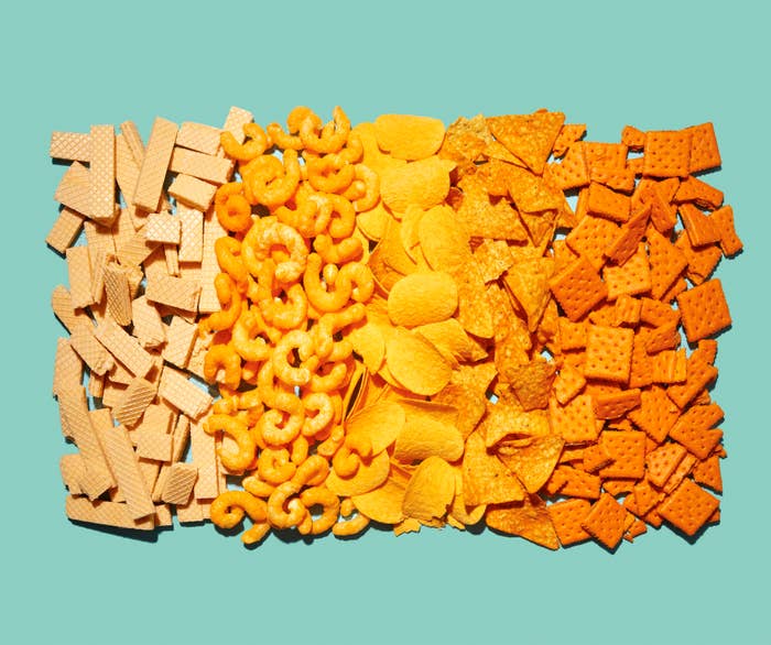 Assorted snack foods arranged on a turquoise background