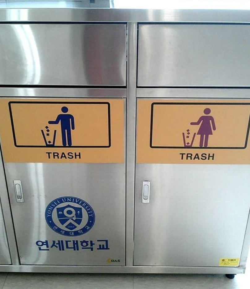 Two gender-specific trash bins with symbols indicating recycling for Seoul University