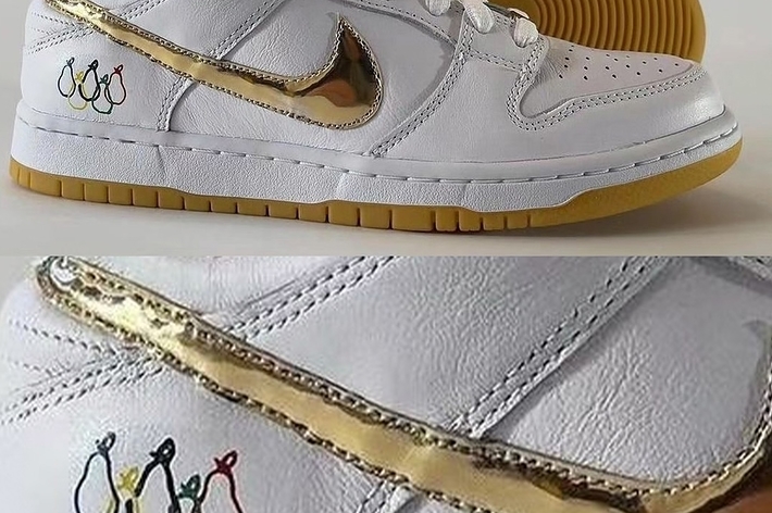 White Nike sneakers with Olympic rings motif and gum sole
