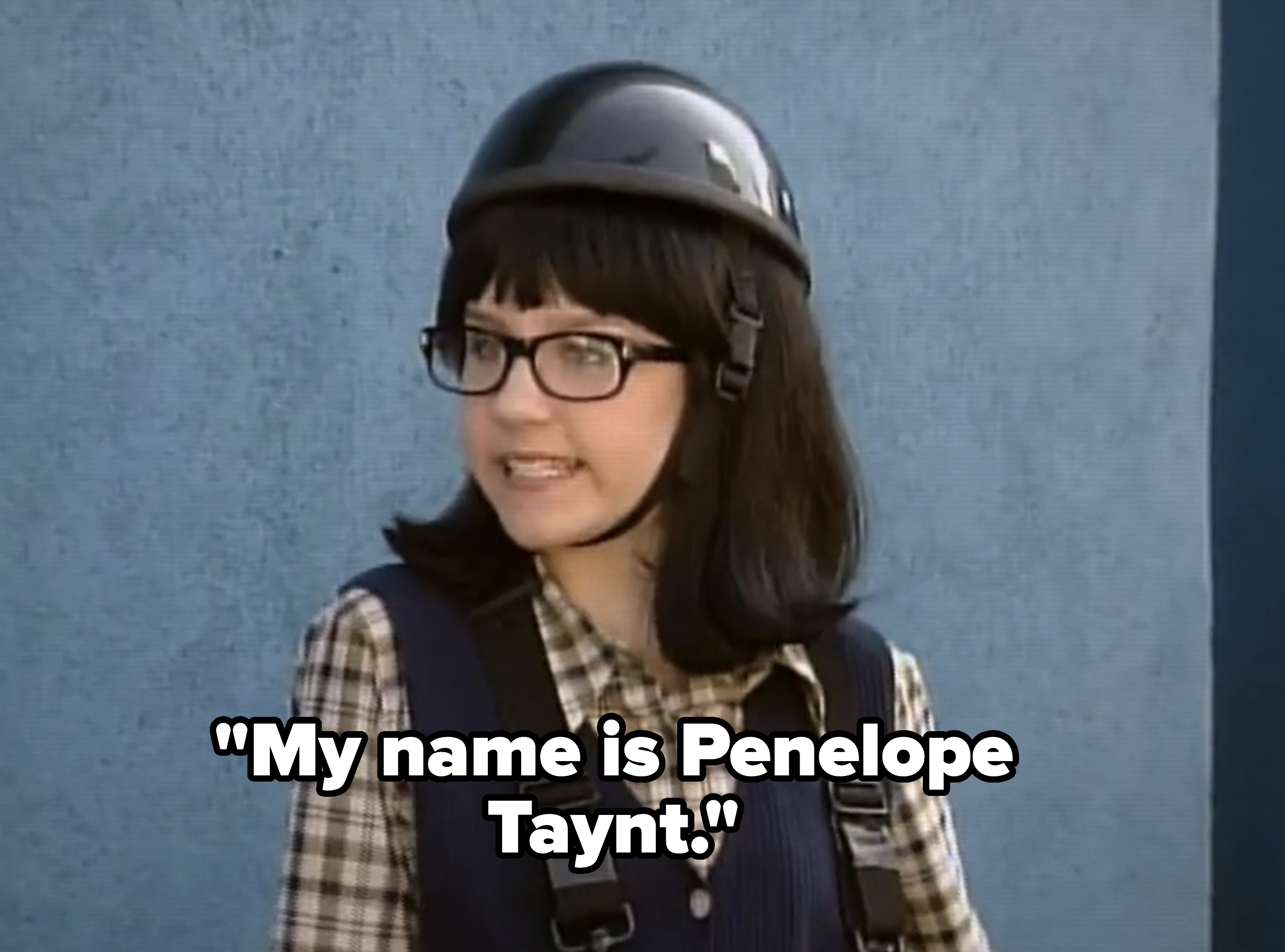 Character with helmet and glasses wearing plaid shirt and overalls