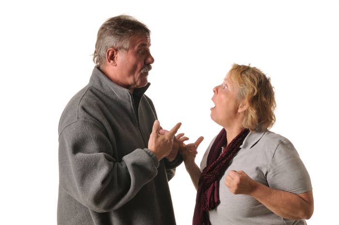 Two adults gesturing in a lively discussion, expressing strong emotions, possibly in a parenting context