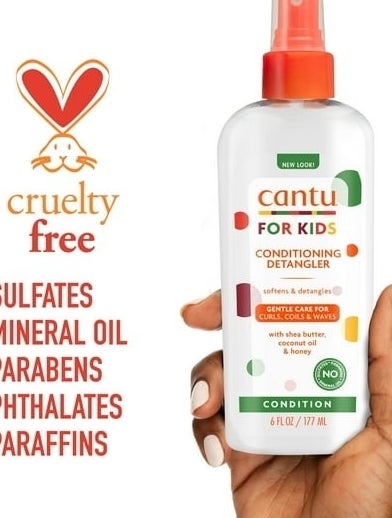Hands presenting Cantu Kids Conditioning Detangler bottle against a white background with orange accents
