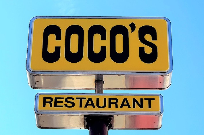 Sign for COCO&rsquo;S RESTAURANT against a clear sky