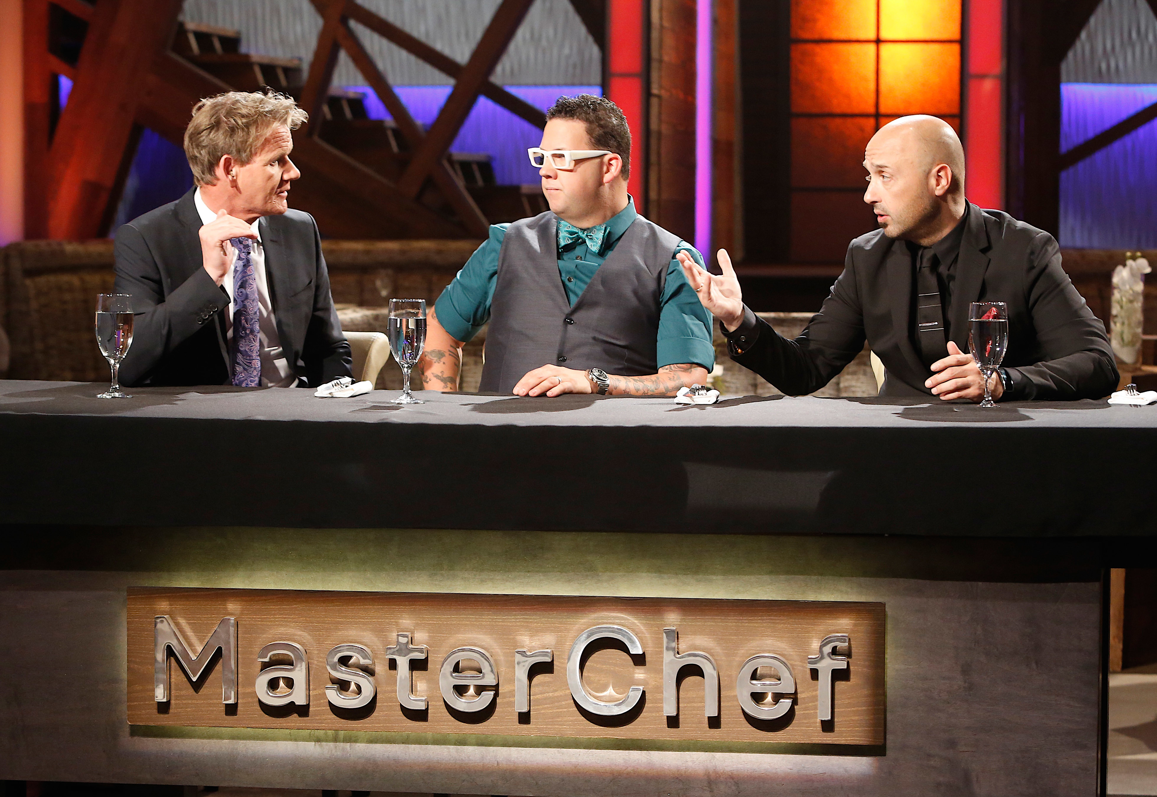 Three judges sit behind the &#x27;MasterChef&#x27; panel, engaging in discussion