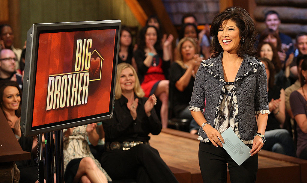 Julie Chen stands next to &#x27;Big Brother&#x27; sign, hosting a show, audience in background