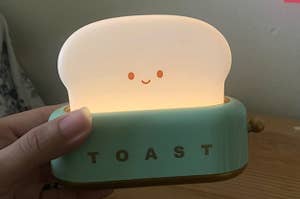 A nightlight shaped like toast coming out of a toaster 