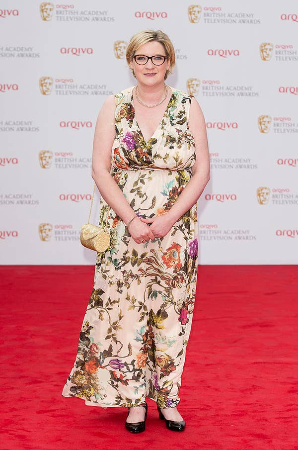 Sarah in floral dress posing on the red carpet at an awards ceremony
