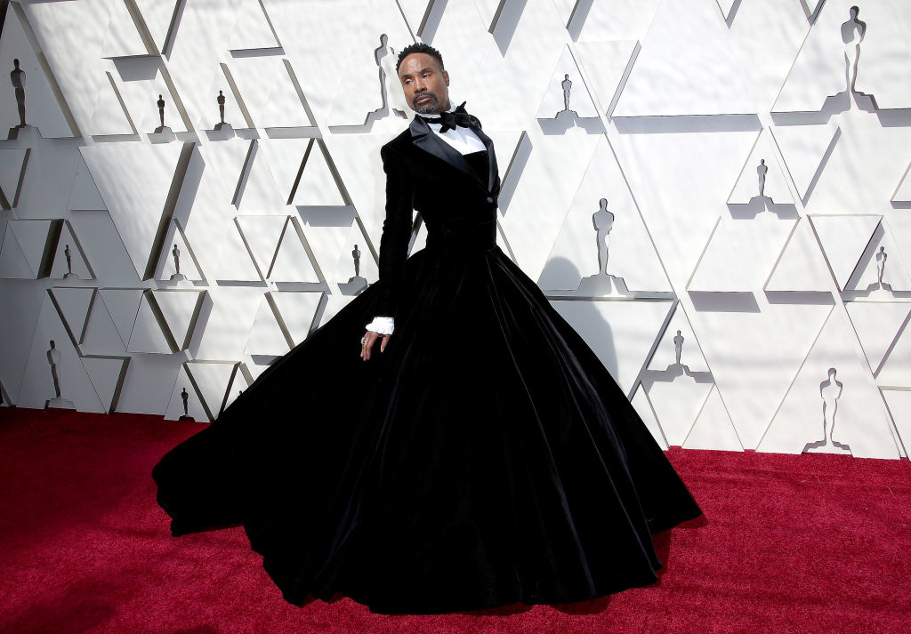 Pose of Billy Porter on red carpet wearing a tuxedo gown