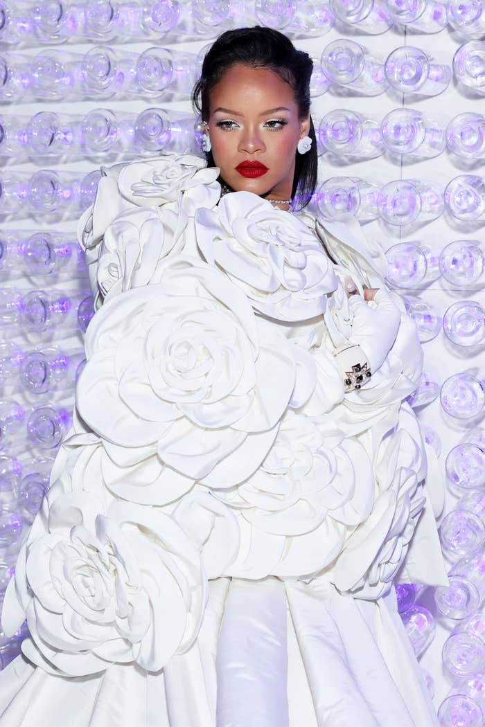 Rihanna wears a voluminous outfit with layered floral design at an event