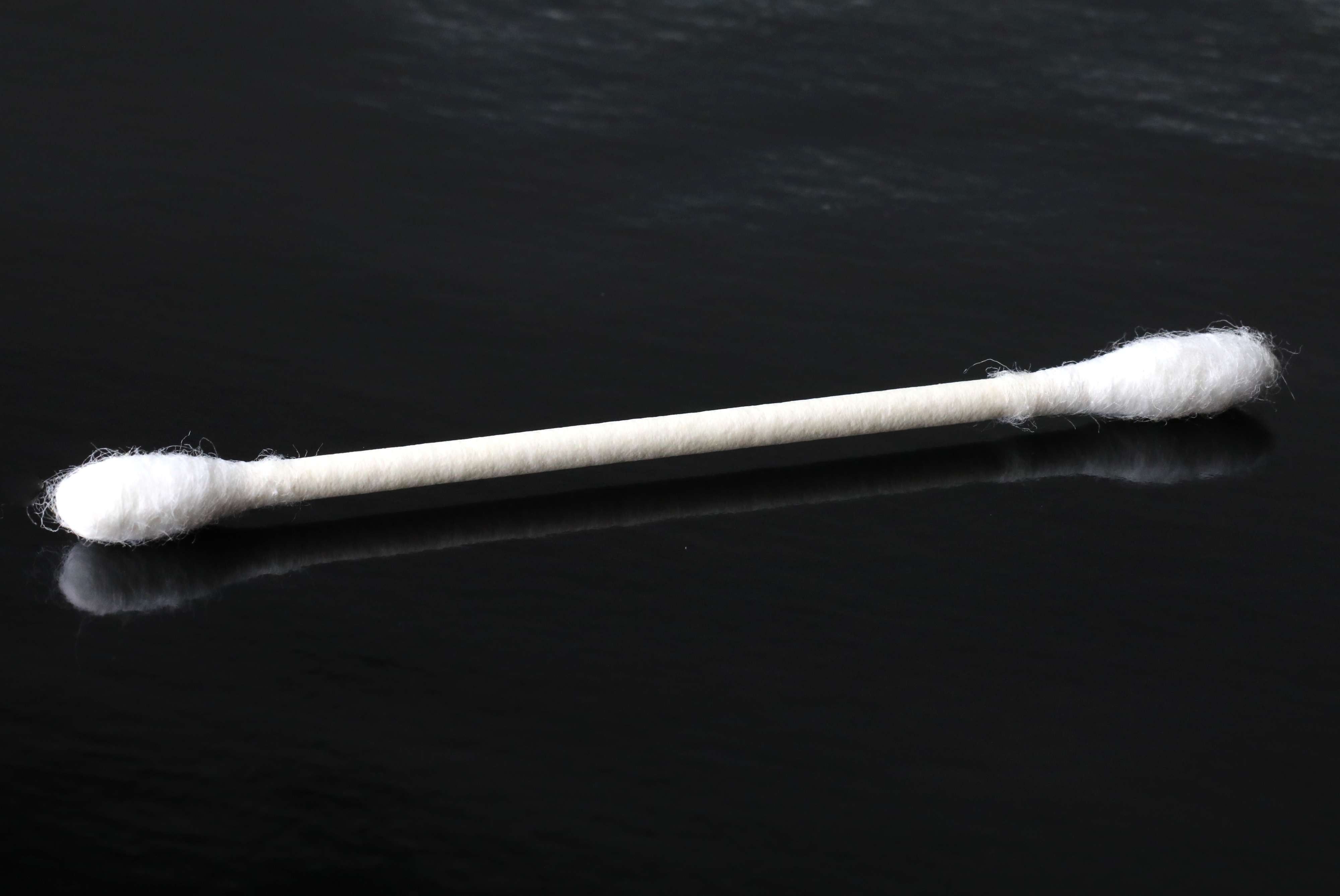 Close-up of a cotton swab on a dark background