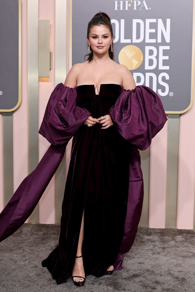 Selena Gomez on the Golden Globes red carpet in a voluminous dark off-shoulder gown