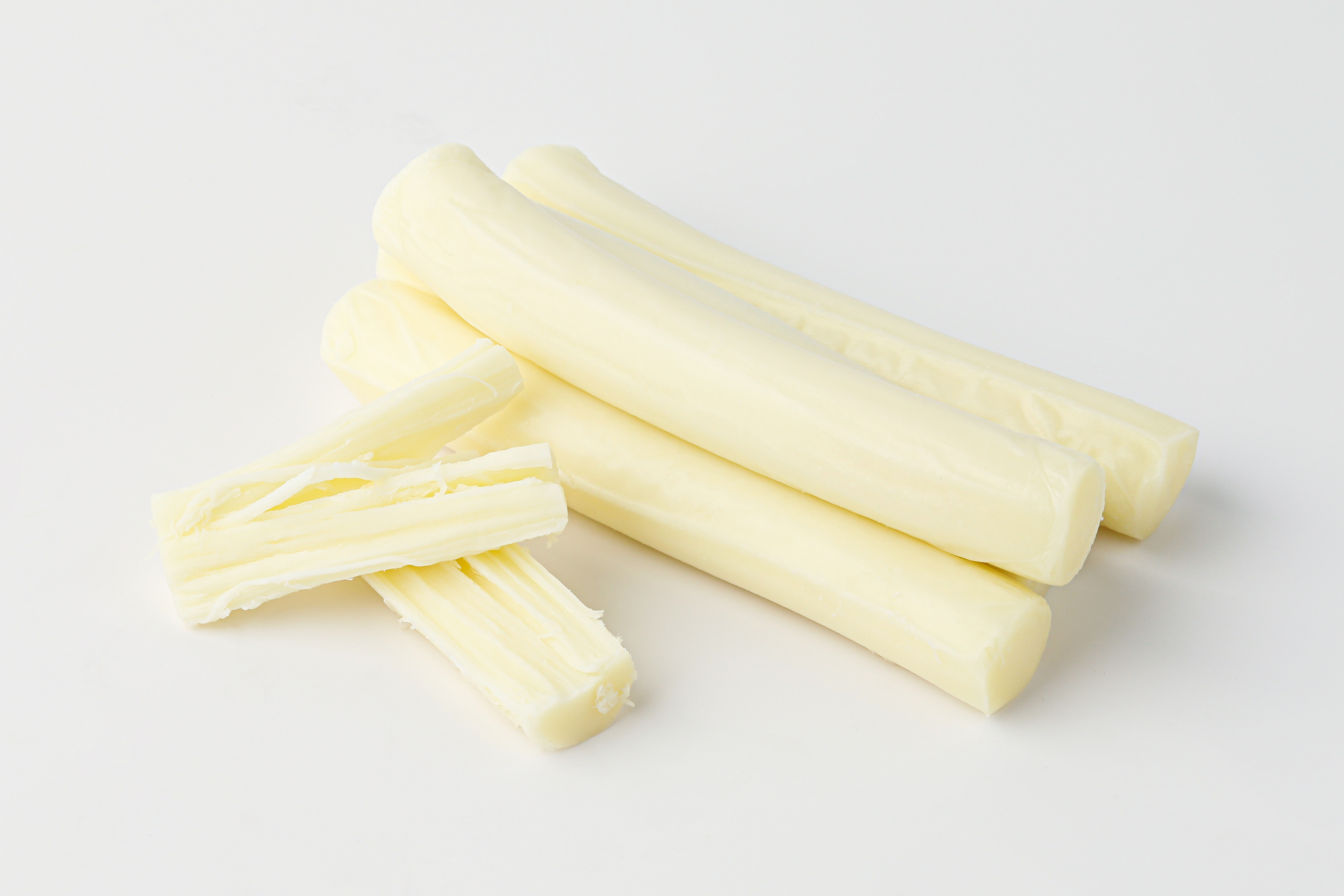 Image of a pile of string cheese sticks on a plain background