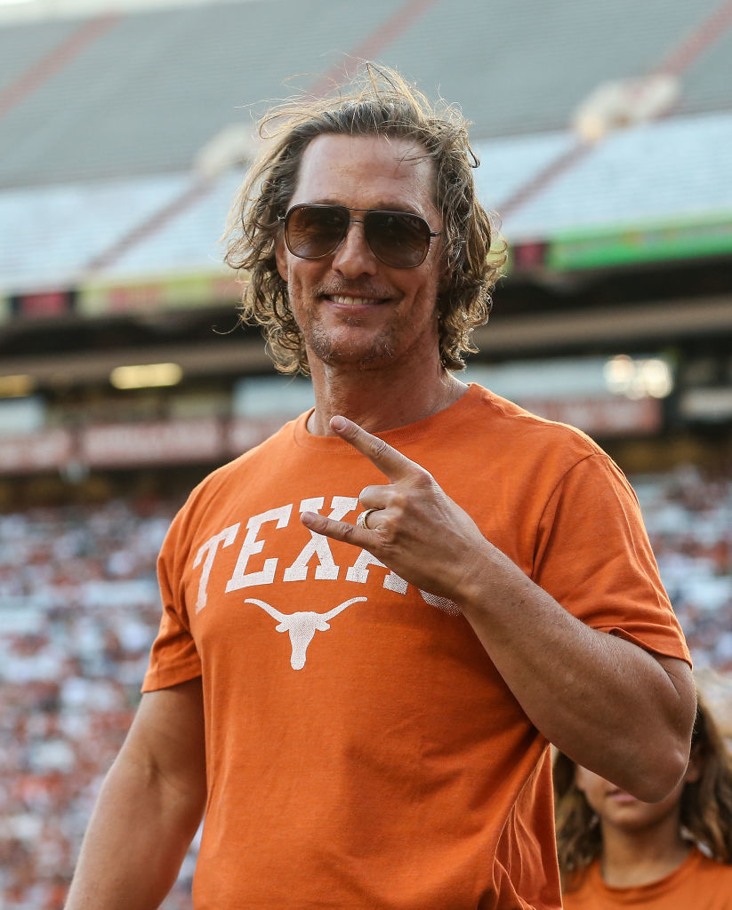 Matthew McConaughey in a Texas Longhorns shirt, giving a thumbs-up