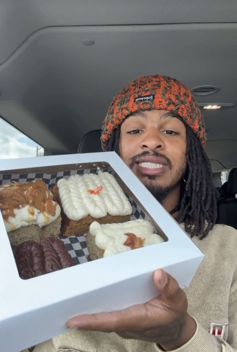 Keith Lee in car showing a box of various frosted pastries