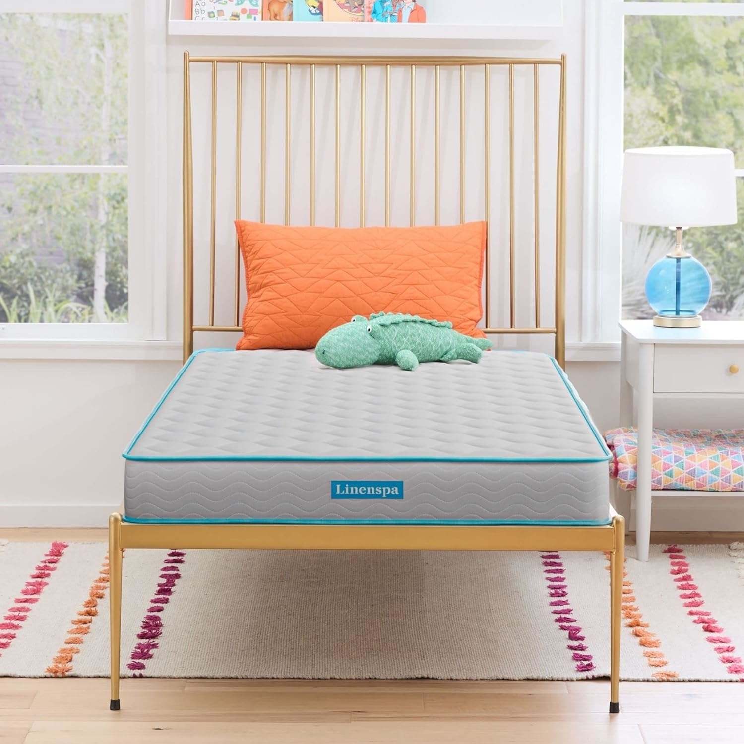 Mattress with bedspread and plush toy on it, in a bedroom setting for a shopping article