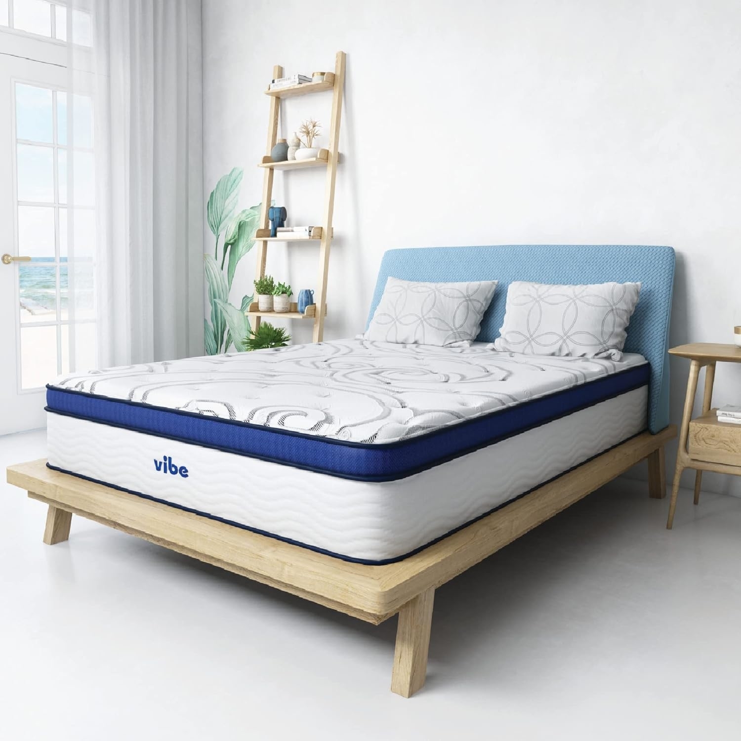 A Vibe branded mattress on a simple wooden bed frame in a bright, modern bedroom setup