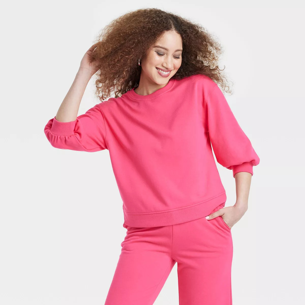 model in the pink sweatshirt and matching pants
