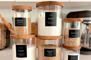 black minimalist pantry labels applied to jars with various dry goods inside