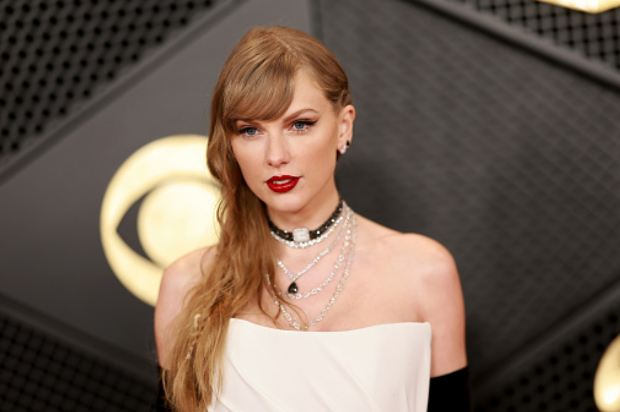 Taylor Swift wearing an off-shoulder gown with layered necklaces