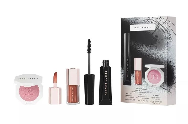 A set of cosmetic products including mascara, lip color, and blush from Fenty Beauty