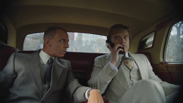 Jeremy and Sebastian in a car as Jeremy takes a phone call