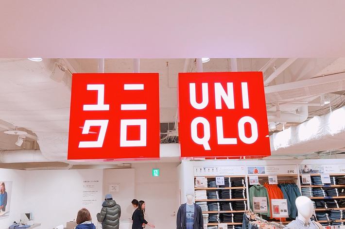 Storefront signs for &ldquo;GU&rdquo; and &ldquo;UNIQLO&rdquo; above clothing displays with mannequins and shoppers