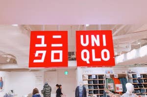 Storefront signs for "GU" and "UNIQLO" above clothing displays with mannequins and shoppers