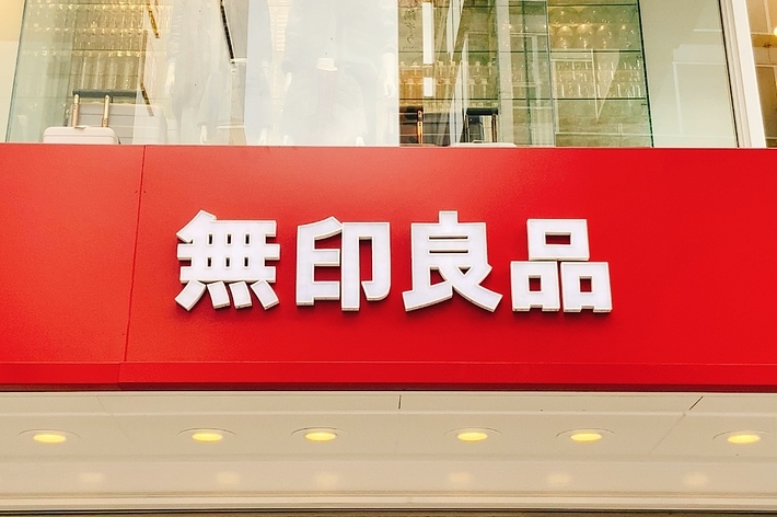 赤い背景に白い日本語の文字が書かれた看板。