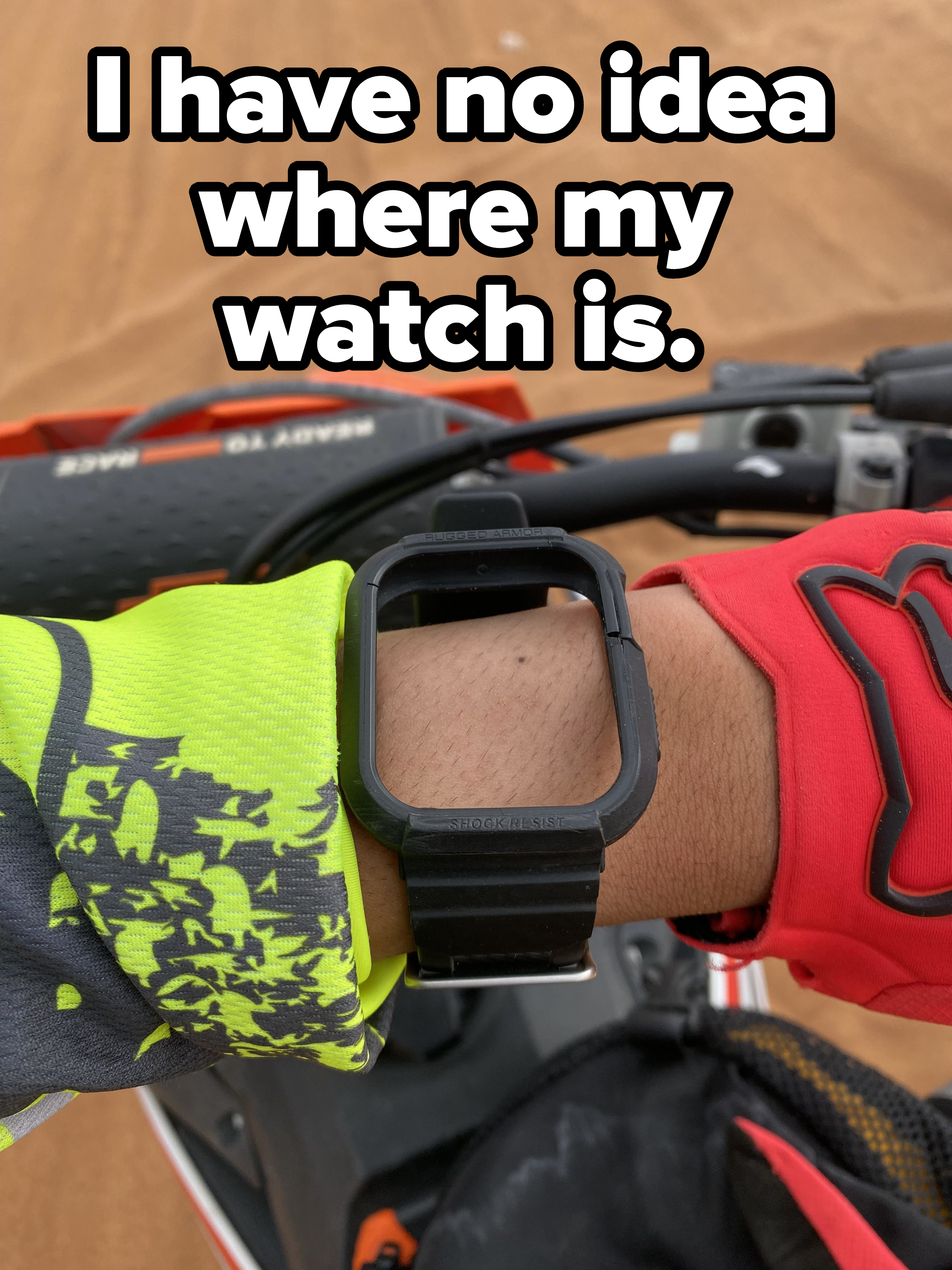 Person wearing a sports watch, red and yellow gloves, and a glimpse of a bicycle handlebar