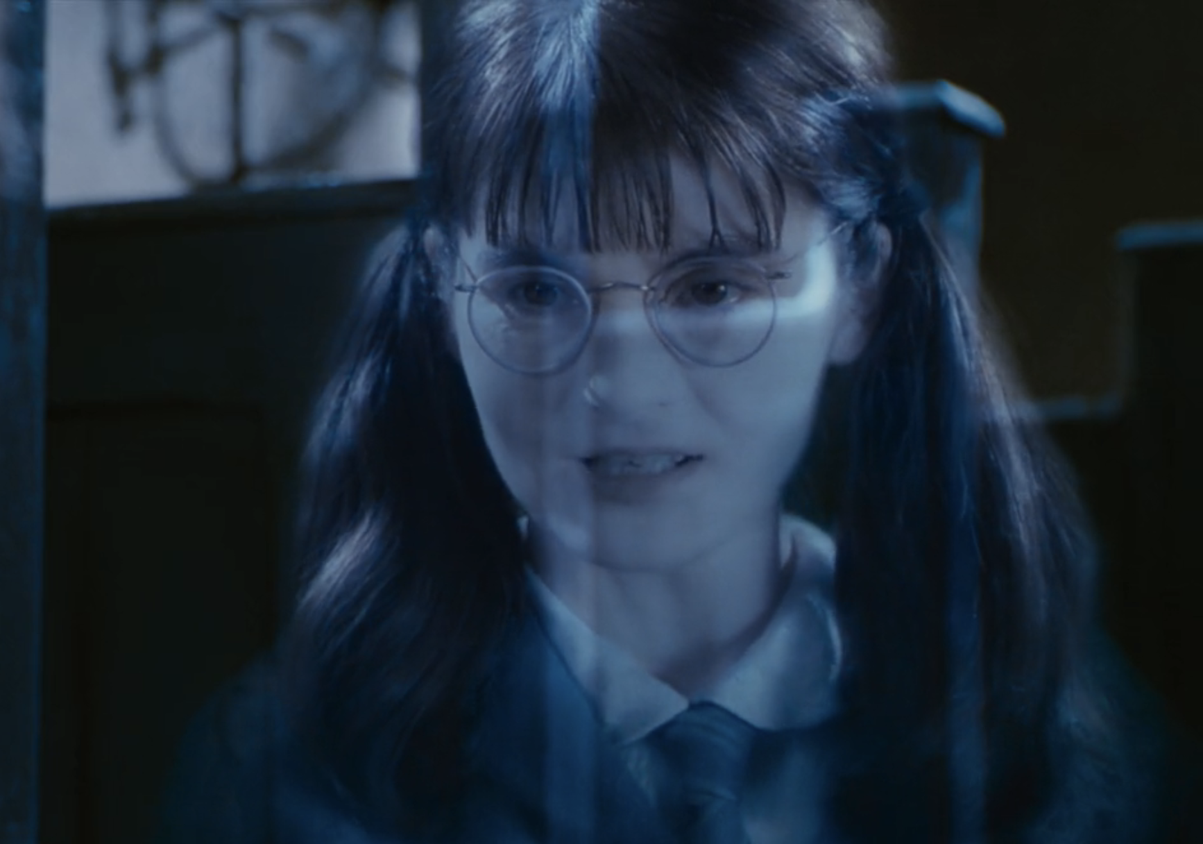 Moaning Myrtle from Harry Potter, wearing Hogwarts robes and glasses