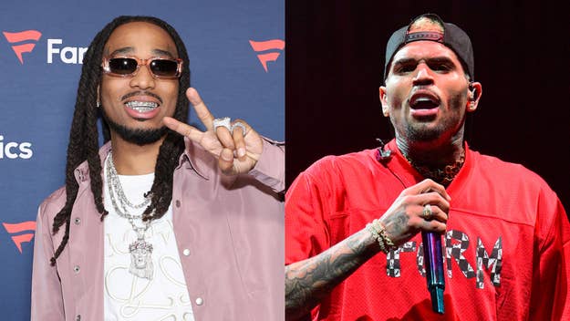 Quavo in a satin jacket and Chris Brown in a red hoodie perform gestures with their hands
