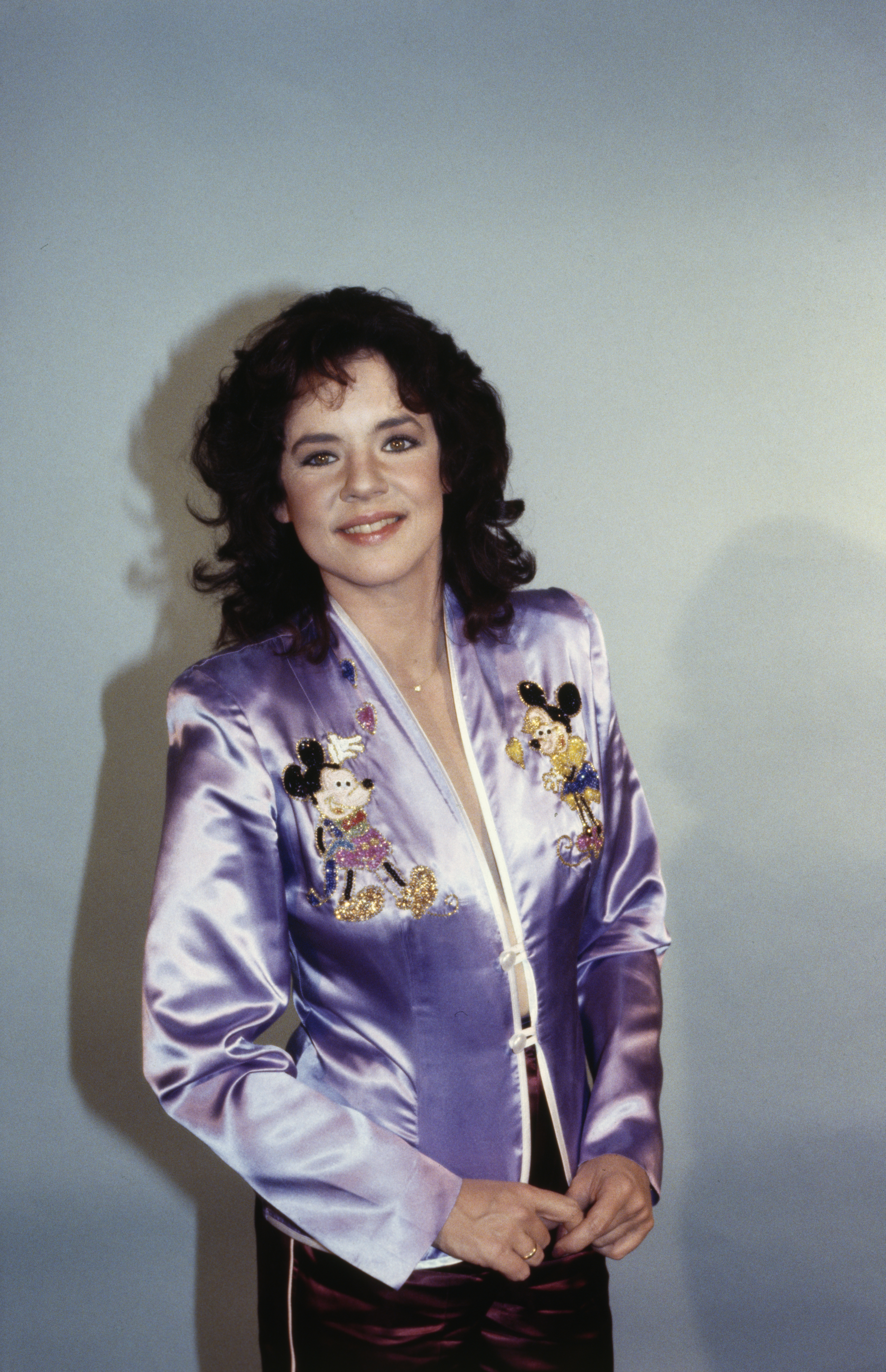 Stockard in a satin blazer with Mickey Mouse motifs, smiling at the camera