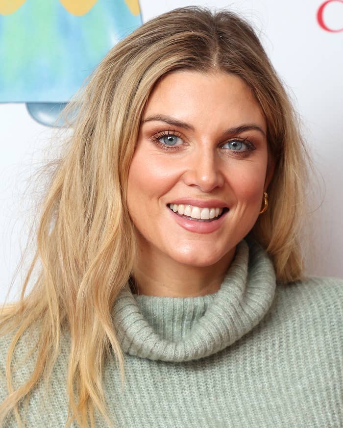 Ashley James at event wearing turtleneck sweater, smiling at camera
