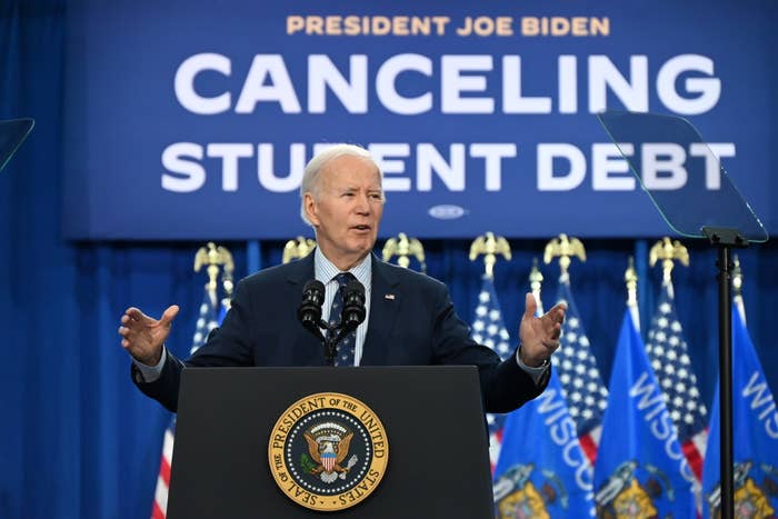 President at a podium with &quot;CANCELING STUDENT DEBT&quot; sign