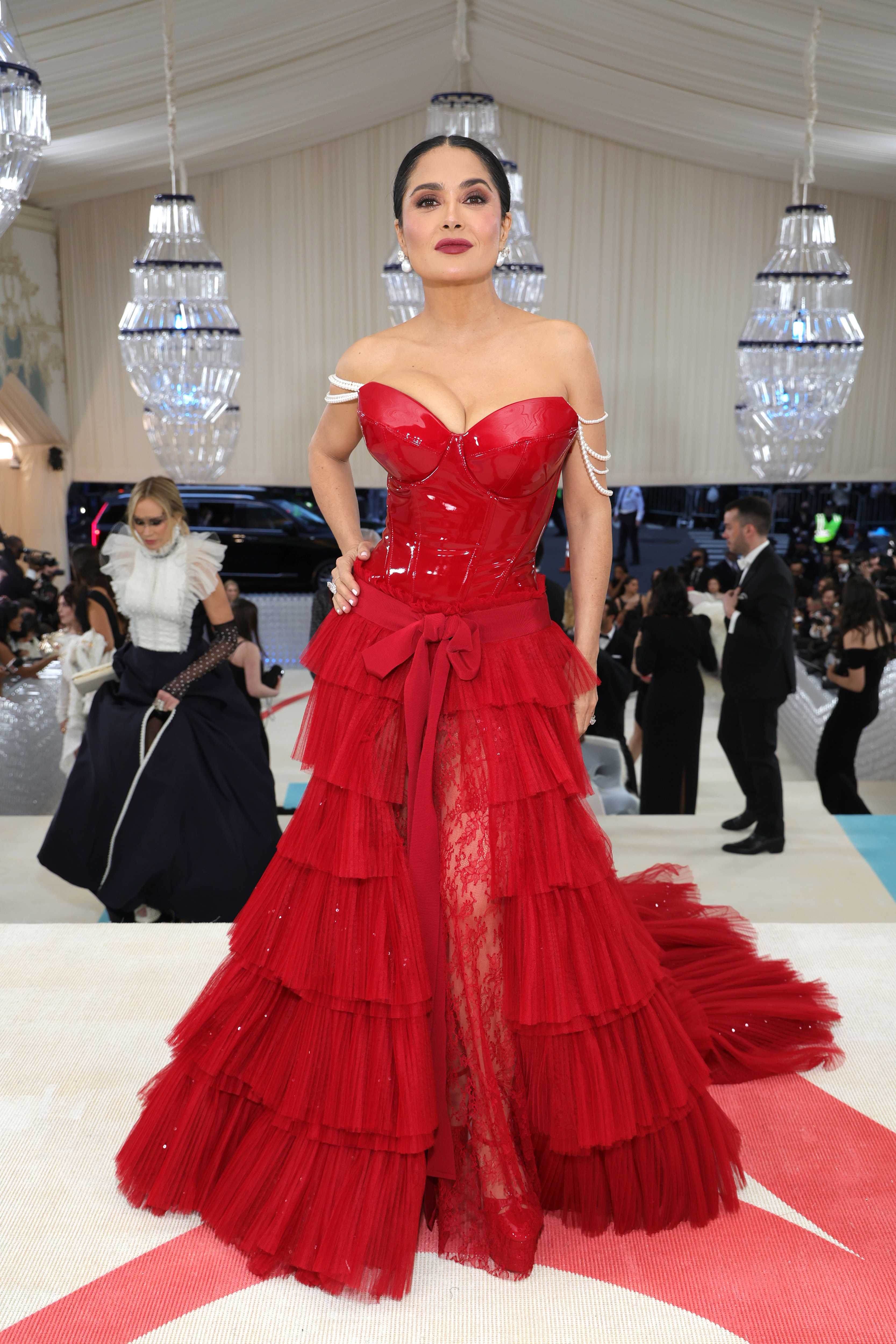Salma Hayek in a red, corseted gown with a voluminous skirt and bow at the Met Gala